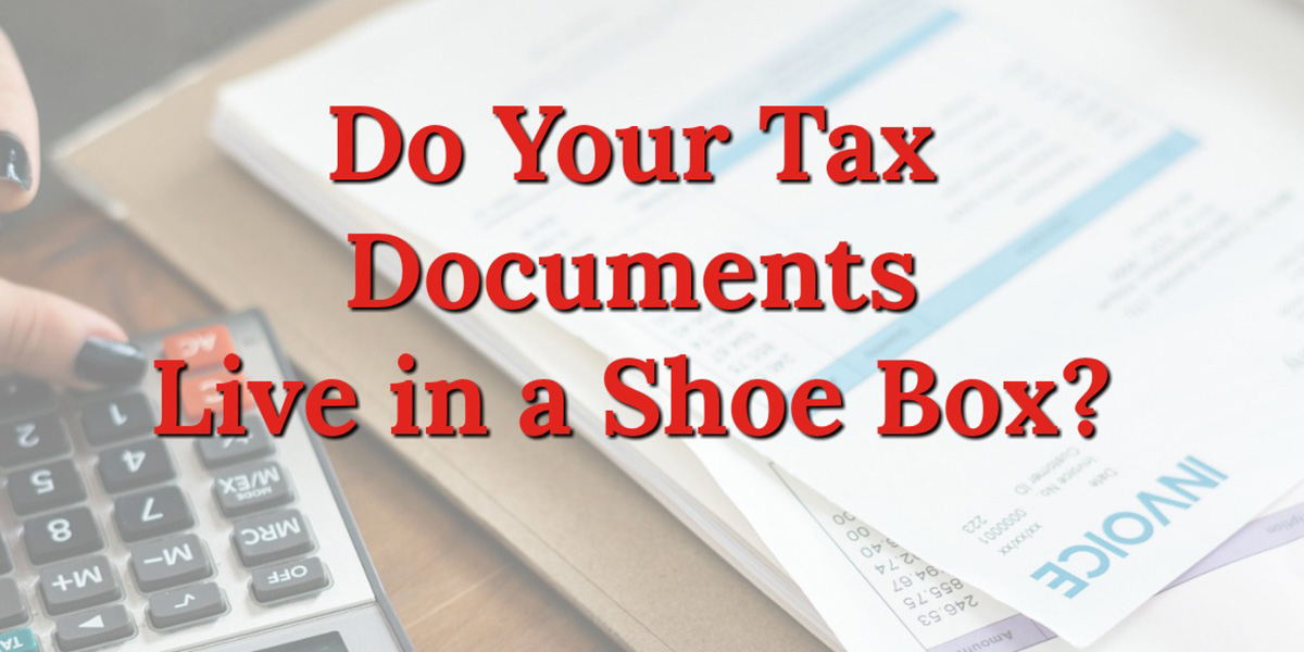 a stack of papers and calculator with text that reads, do your tax documents live in a shoe box?