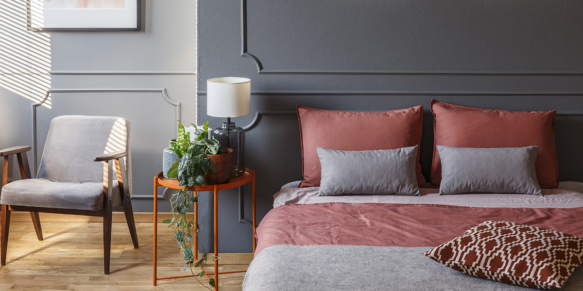 a photo of a bedroom with a made bed and clutter free